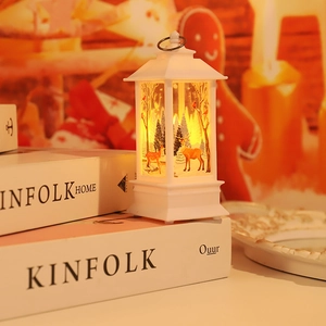 Close-up of white Christmas lantern with reindeer scene and warm LED light