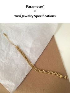 Detail of gold flat herringbone chain necklace with adjustable lobster clasp and tag