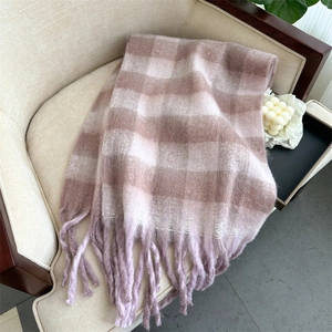 Close-up of soft pink and purple plaid cashmere scarf with delicate fringe details