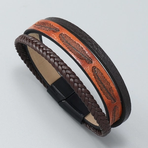 Detail of braided leather bracelet with embossed feather pattern and magnetic clasp