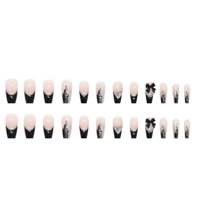 Y2K coffin press-on nails with 3D bows, rhinestones, and silver glitter on white background