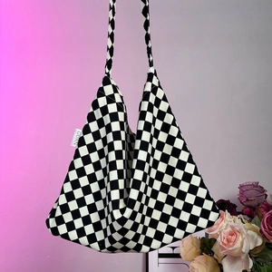 Large capacity canvas tote bag with black and white checkerboard pattern and shoulder straps