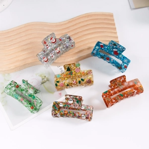 Glitter acrylic Christmas star and snowman hair claws in various vibrant colors