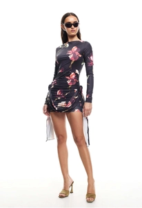 Detail of black floral mini dress featuring side drawstrings and ruched bodycon fit