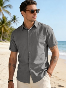 Close-up of men's dark grey cotton linen beach shirt with button and natural fabric texture
