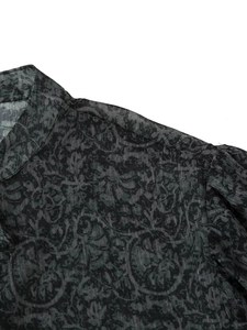 Close-up of black floral print fabric with vertical silver metallic thread details