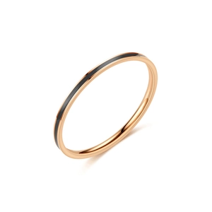 Detailed close-up of slim rose gold titanium steel ring with black enamel center band