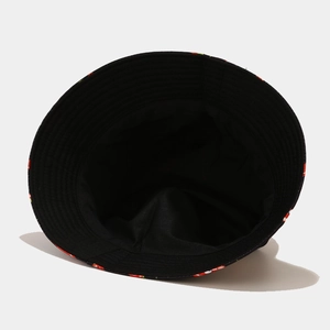 Detail of the reversible bucket hat interior showing fine stitching and red chili patterns