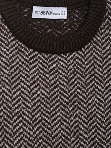 Close-up of brown herringbone knit vest neck with ribbed collar and brand label