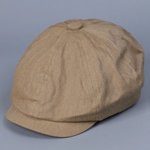 Detail of khaki cotton newsboy cap with classic eight-panel top and neat stitching