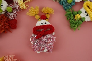 Detailed macro view showing the handmade crochet texture and metal ring of the monster charm