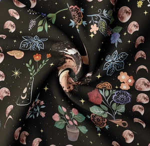 Macro detail of mystical butterfly tapestry fabric showing floral print and moon phases