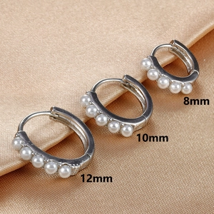 Close-up showing three sizes (8mm, 10mm, 12mm) of silver pearl hoop earrings on satin