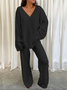 Women's black two-piece knit lounge set with V-neck long sleeve top and wide leg pants