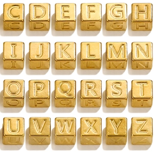 Macro view of golden square stainless steel letter beads for DIY jewelry making