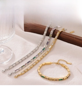 Detailed view of square colorful zircon crystals on polished gold and silver bracelets