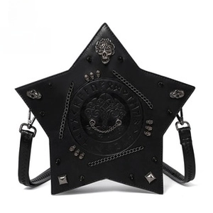 Detail of gothic star bag with skull emblem, metal chains, and embossed rune pattern