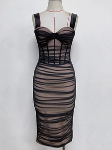Detail of ruched velvet mesh dress featuring corset boning and sheer panel design