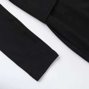 Detail of delicate lace stitching and high-quality knit texture on a black V-neck sleeve