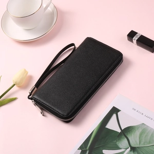 Detail of black pebbled PU leather long wallet with silver zipper and wrist strap