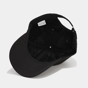 Inside view of black clover print baseball cap showing six-panel stitch and breathable fabric
