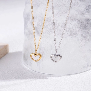 Elegant gold and silver heart necklaces with mother-of-pearl inlays on paperclip chains