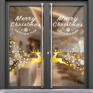 Detail of gold reindeer and white snowflake static stickers on a glass door surface