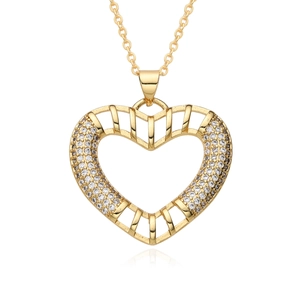 Close-up of heart-shaped hollow pendant with gold plating and sparkling white zirconias