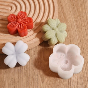 Detailed view of white silicone flower molds and colorful handmade floral resin crafts