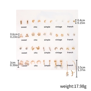 Detailed view of gold earring set showing assorted heart and pearl studs with dimensions