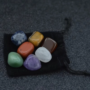 Detailed set of 7 polished natural chakra stones with a black velvet pouch for healing