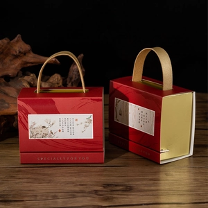 Detail of red and gold Chinese wedding candy box with elegant calligraphy and golden handles