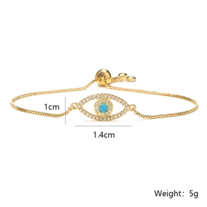 Detailed close-up of gold Evil Eye bracelet with blue stone and cubic zirconia details