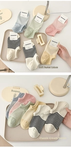 Close-up of pastel striped cotton boat socks with cream tones in a lifestyle setting