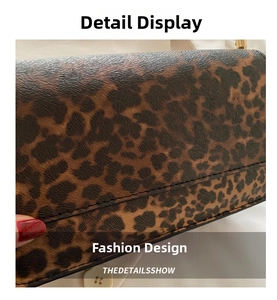 Close-up of leopard print handbag showing grainy leather texture and stitching detail