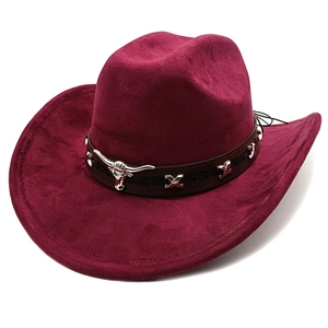 Detail of burgundy western cowboy hat featuring leather band and silver bull head ornament