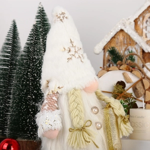 Close-up of plush Christmas gnome with sequin snowflake hat and white braided beard details