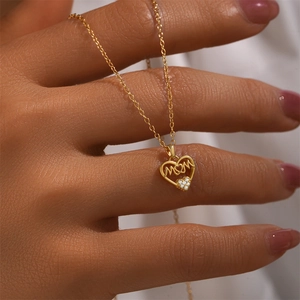 Detail of s925 silver heart MOM necklace with cubic zirconia pendant on skin