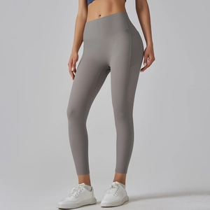 Detail view of high-waisted grey yoga leggings with side pockets and seamless matte fabric