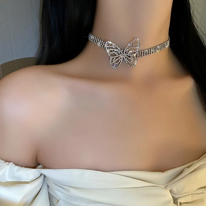 Close-up of sparkling three-row rhinestone choker with a luxury silver butterfly pendant