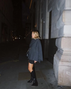 Chic dark grey wool cape coat paired with stylish black boots in an urban street setting