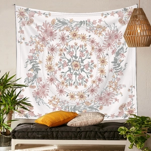 Mandala floral tapestry in pink and yellow hanging above a black bench in a cozy room