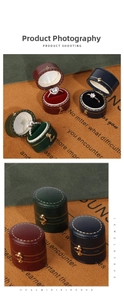 Close-up of vintage oval mini ring boxes in velvet and leather with gold metal clasps