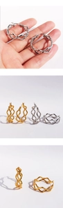 Detailed close-up showing textured double-layer wavy snake skin pattern hoop earrings