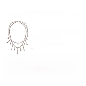 Detailed view of layered necklace with faux pearls, zircons and teardrop pendants