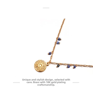 Close-up of 18K gold plated brass sun pendant necklace with blue cubic beads