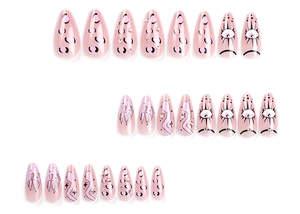 Macro detail of long stiletto false nails with pink leopard print and eye pattern