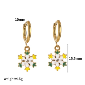 Detailed size view of gold snowflake hoop earrings with enamel and crystal accents
