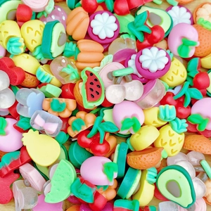 Close-up of colorful resin fruit charms like watermelon and strawberry for DIY crafts