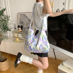 Detail of large canvas tote bag with tulip floral print shown in stylish home setting